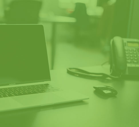Shaded image of phone and laptop on desk